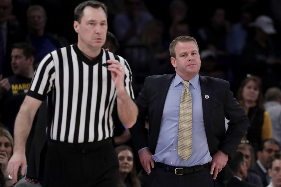 Marquette head coach Steve Wojciechowski, right, looks in the direction of official James Breeding during the second half of an NCAA college basketball semifinal game against Seton Hall in the Big East men's tournament, Friday, March 15, 2019, in New York. Seton Hall won 81-79. (AP Photo/Julio Cortez)