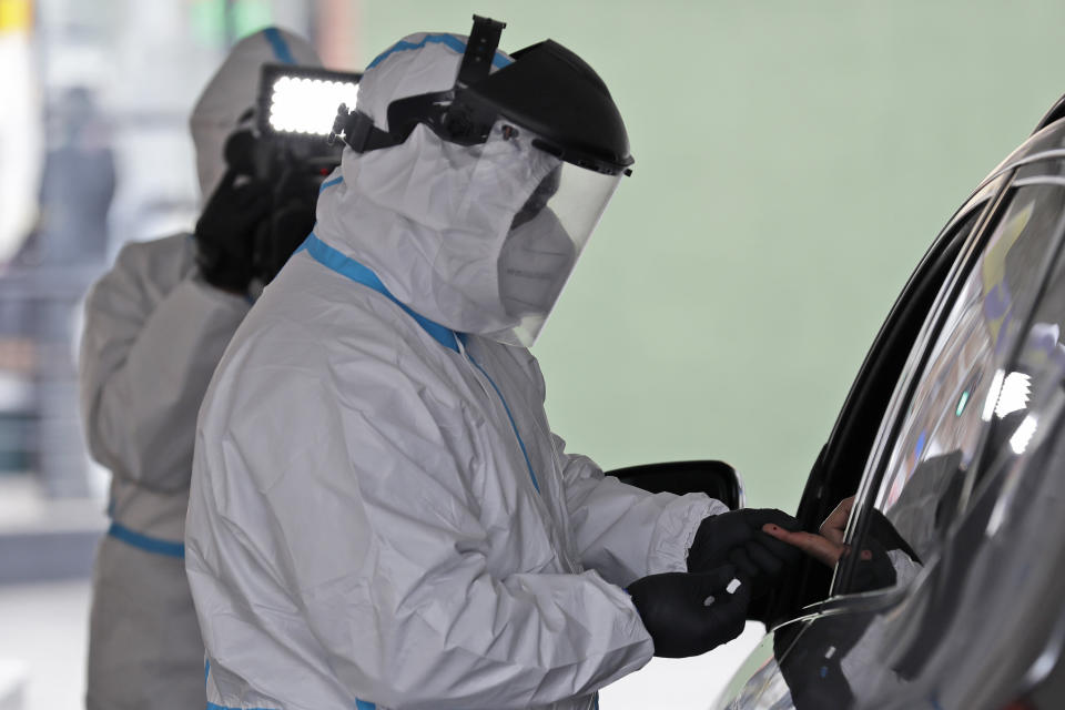 A person's blood is collected for testing of coronavirus antibodies at a drive-thru testing site in Hempstead, N.Y., Tuesday, April 14, 2020. The test, being administered by Somos Community Care, takes approximately 15 minutes and tests for the presence of antibodies in a person's blood, signifying that they may have some immunity to the coronavirus. (AP Photo/Seth Wenig)