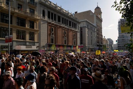 Demonstrators take part in a protest against Madrid's new conservative People's Party (PP) municipal government plans to suspend some anti-car emissions policies in Madrid's city center