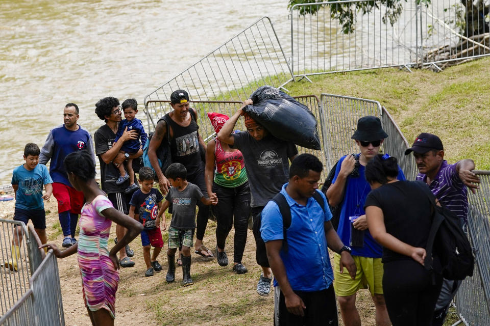Migrants heading north arrive at a camp after riding a boat to Lajas Blancas, Darien province, Panama, Friday, Oct. 6, 2023, after walking across the Darien Gap from Colombia. (AP Photo/Arnulfo Franco)