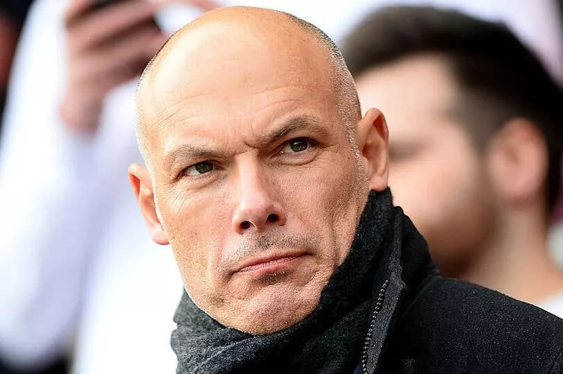 Former Referee Howard Webb looks on