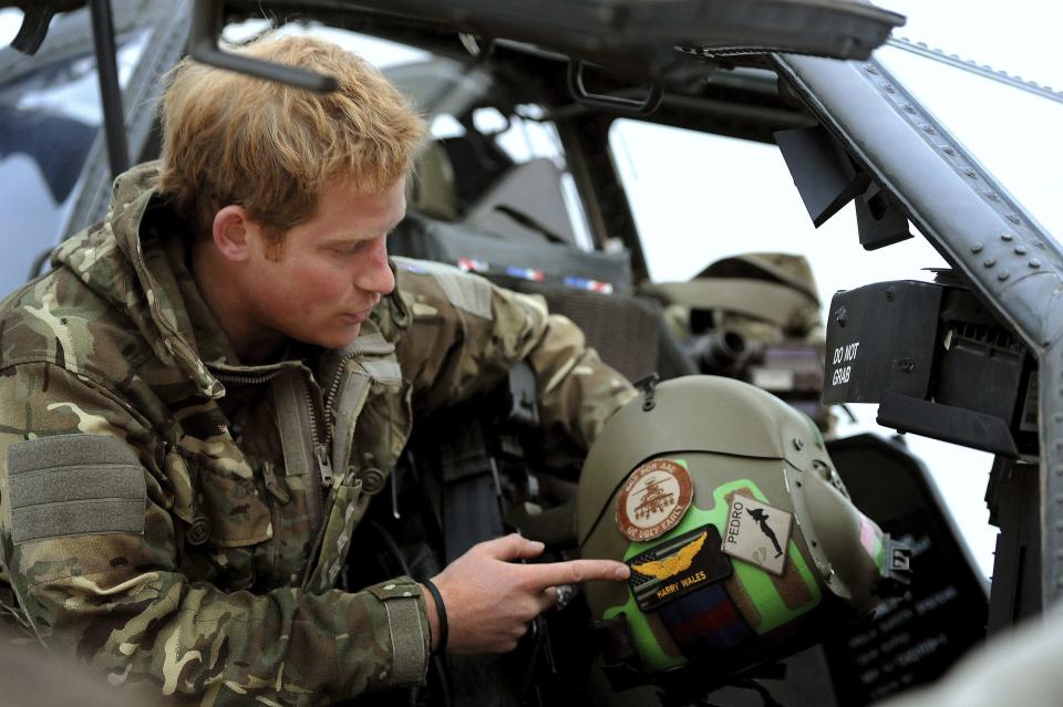 Prince Harry gave a series of intimate interviews to mark the end of his 20-week tour in Afghanistan. Here he shows off his helmet with his name on it - Captain Wales - in an Apache helicopter which he co-pilots (Reuters)