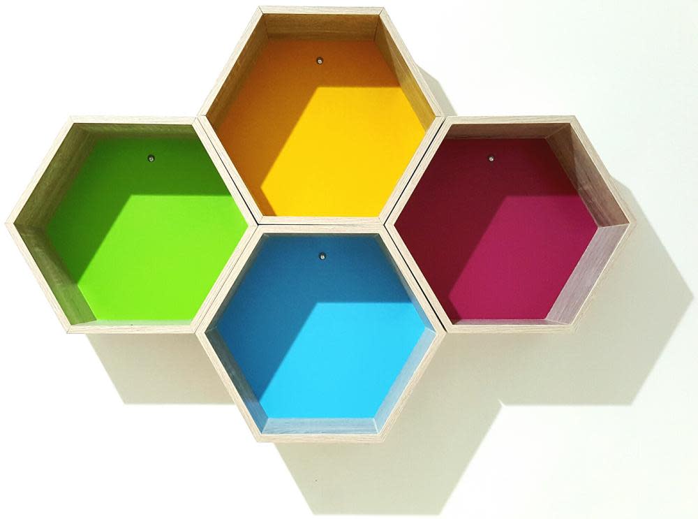 Close-Up Of Multi Colored Hexagon Shapes Mounted On Wall