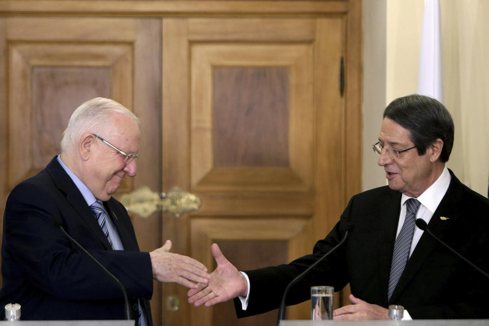 Cyprus' President Nicos Anastasiades, right, shakes hands with Israel's President Reuven Rivlin after their meeting at the presidential palace in divided capital Nicosia, Cyprus, Tuesday, Feb. 12, 2019. Rivlin is in Cyprus for a one-day official visit for talks. (AP Photo/Petros Karadjias)