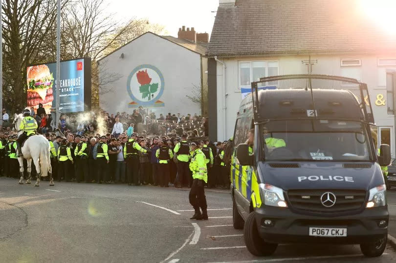 Police are seen outside Ewood Park as fans arrive prior to the match between Blackburn Rovers and Burnley in 2023