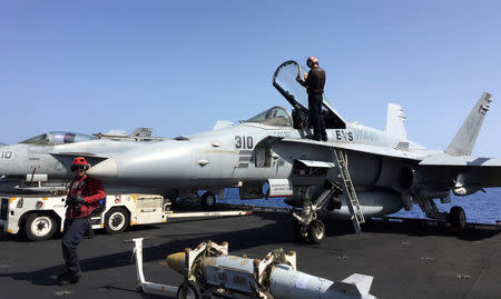 FILE PHOTO: Specialists inspect F/A-18 fighter jet aboard the USS Harry S. Truman aircraft carrier in the eastern Mediterranean Sea, June 7, 2016. REUTERS/Andrea Shalal/File Photo