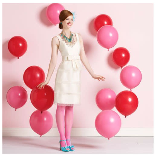 Use balloons to frame a photo booth at your reception. (Love the dress? Get it from Kate Spade.)