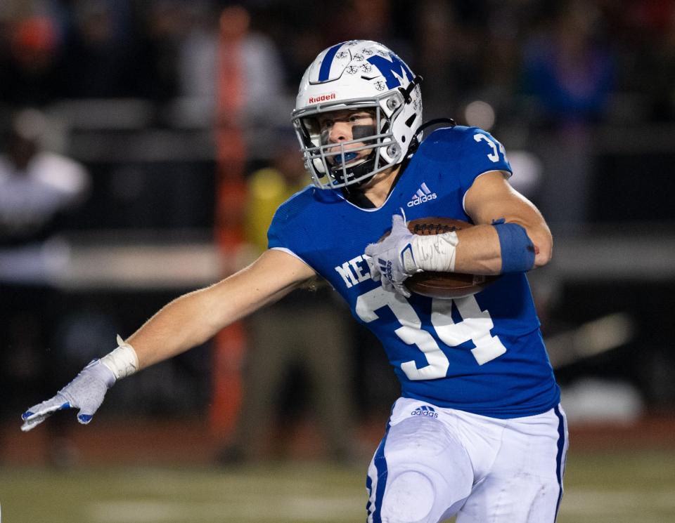 Memorial's William Rogers (34) runs with the ball during the IHSAA Class 4A semistate between the Memorial Tigers and the Mt. Vernon Marauders at Enlow Field in Evansville, Ind., Friday evening, Nov. 19, 2021.