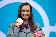 Gold medallist <a href="http://sports.yahoo.com/olympics/swimming/rebecca-soni-1131469/" data-ylk="slk:Rebecca Soni;elm:context_link;itc:0;sec:content-canvas" class="link ">Rebecca Soni</a> of the United States poses on the podium during the medal ceremony for the Women's 200m Breaststroke Final on Day 6 of the London 2012 Olympic Games at the Aquatics Centre on August 2, 2012 in London, England. Soni set a new world record time of 2:19.59 for the event. (Photo by Adam Pretty/Getty Images)