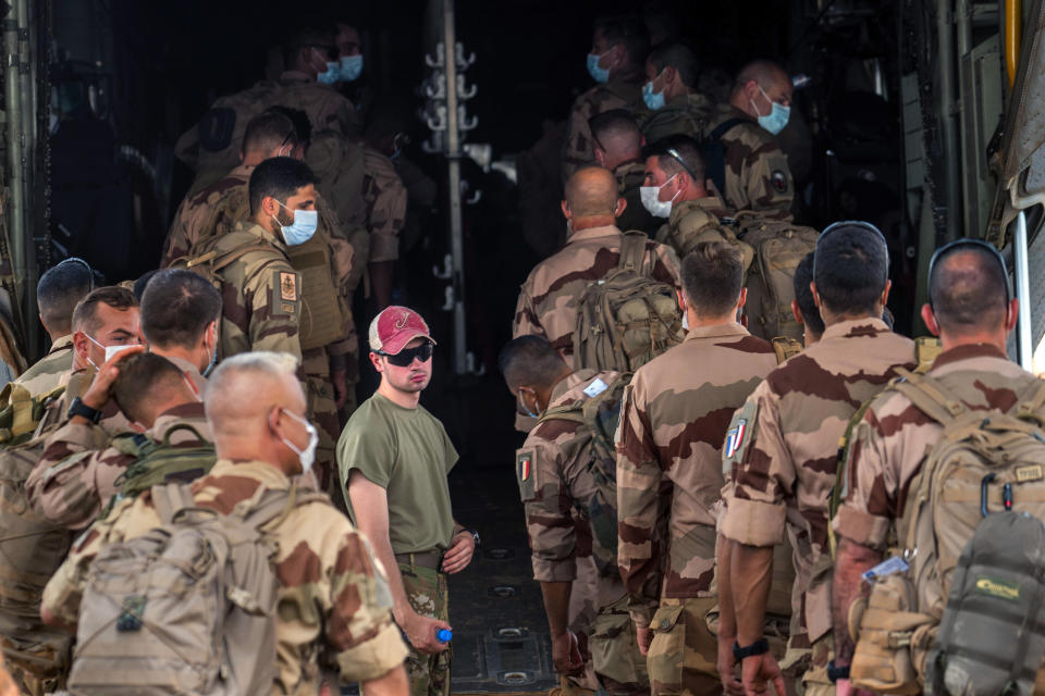 French Barkhane force soldiers who wrapped up a four-month tour of duty in the Sahel board a US Air Force C130 transport plane, leave their base in Gao, Mali, Wednesday June 9, 2021. France has suspended joint military operations with Malian forces until the junta led by Col. Assimi Goita, who retook control of Mali's transitional government May 24, complies with international demands to restore civilian rule. (AP Photo/Jerome Delay)