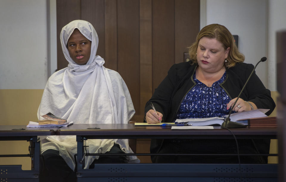 Subhannah Wahhaj, left, sits with her attorney Megan Mitsunaga during a hearing on a motion to dismiss in the Taos County Courthouse, Wednesday, Aug. 29, 2018. Judge Emilio Chavez ordered charges against Wahhaj and two other defendants dropped as the result of a deadline missed by prosecutors. (Eddie Moore/The Albuquerque Journal via AP, Pool)