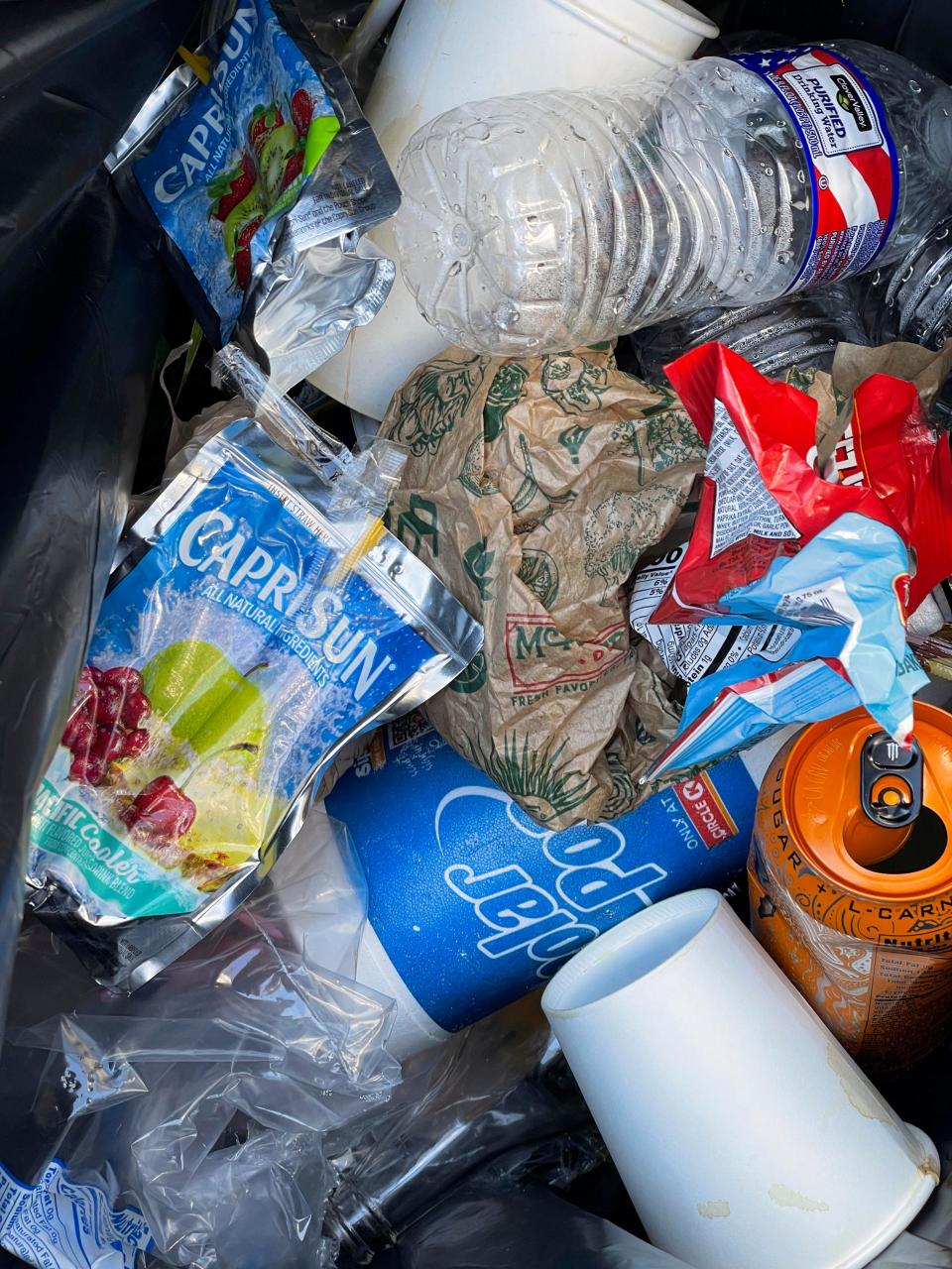 Trash fills a bin on Okaloosa Island recently. Saltwater Restaurants and the Destin-Fort Walton Beach Tourist Development Department will host beach cleanups Saturday at six locations along the coast, from Okaloosa Island east to Miramar Beach.