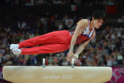 Japan's gymnast Kohei Uchimura competes on the pommel horse during the men's team final of the artistic gymnastics event of the London Olympic Games at the 02 North Greenwich Arena in London