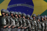 <p>Brazilian Army soldiers take part in military exercise during presentation of the security forces for the Rio 2016 Olympic Games, in front of the National Stadium, in Brasilia, Brazil, Friday, July 22, 2016. Security has emerged as the top concern during the Olympics, including violence possibly spilling over from Rio’s hundreds of slums. Authorities have said 85,000 police officers and soldiers will be patrolling during the competitions. (AP Photo/Eraldo Peres)</p><p><br></p>