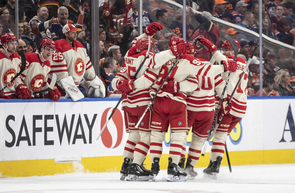 Calgary Flames celebrate a goal against the Edmonton Oilers during the second period of an NHL hockey game Saturday, Feb. 24, 2024, in Edmonton, Alberta. (Jason Franson/The Canadian Press via AP)