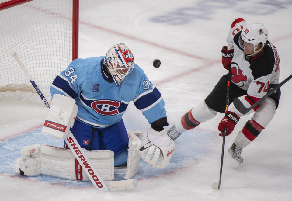 New Jersey Devils' Jesper Boqvist moves in on Montreal Canadiens goaltender Jake Allen during the second period of an NHL hockey game, Tuesday, Nov. 15, 2022 in Montreal. (Graham Hughes/The Canadian Press via AP)