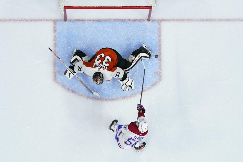 Philadelphia Flyers' Samuel Ersson, left, blocks a shot by Montreal Canadiens' Jesse Ylonen during a shootout in an NHL hockey game, Wednesday, Jan. 10, 2024, in Philadelphia. (AP Photo/Matt Slocum)