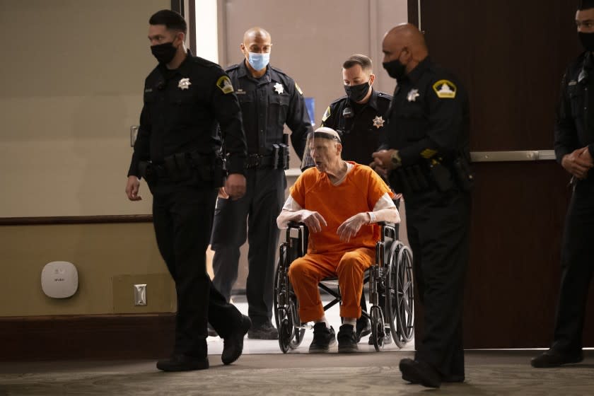 Sacramento County Sheriff's Deputies use a wheelchair to bring Joseph James DeAngelo into the courtroom in Sacramento Superior Court in Sacramento, Calif. Monday, June 29, 2020. DeAngelo, 74, pleaded guilty to 13 counts of murder and multiple other charges 40 years after a sadistic series of assaults and slayings in California. Due to the large numbers of people attending, the hearing was held at a ballroom at California State University, Sacramento to allow for social distancing. (AP Photo/Rich Pedroncelli)