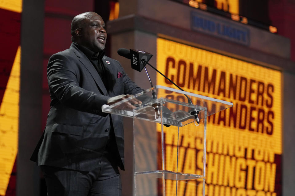 Former football player London Fletcher announces Illinois defensive back Jartavius Martin as the selection by the Washington Commanders during the second round of the NFL football draft, Friday, April 28, 2023, in Kansas City, Mo. (AP Photo/Jeff Roberson)