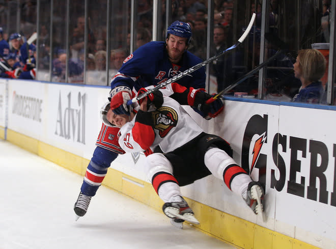   Erik Karlsson #65 Of The Ottawa Senators Is Checked By Brandon Prust #8 Of The New York Rangers In Game Two Of The Getty Images