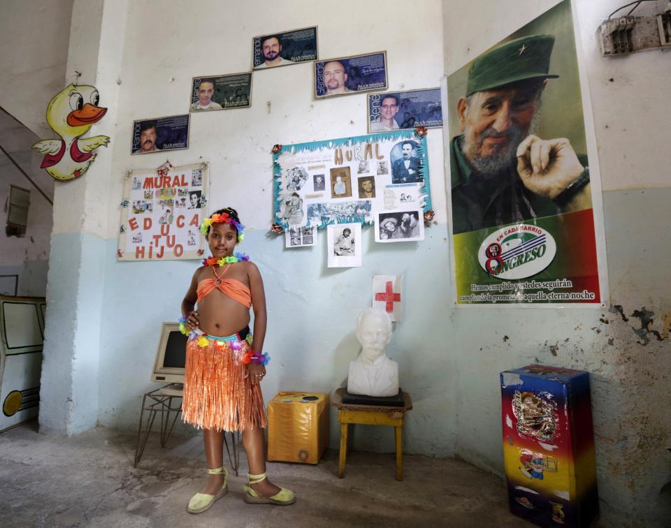 Third grade student at the Enrique Villuendas Primary School, Ana Fernandez, poses in her Hawaiian costume in Havana