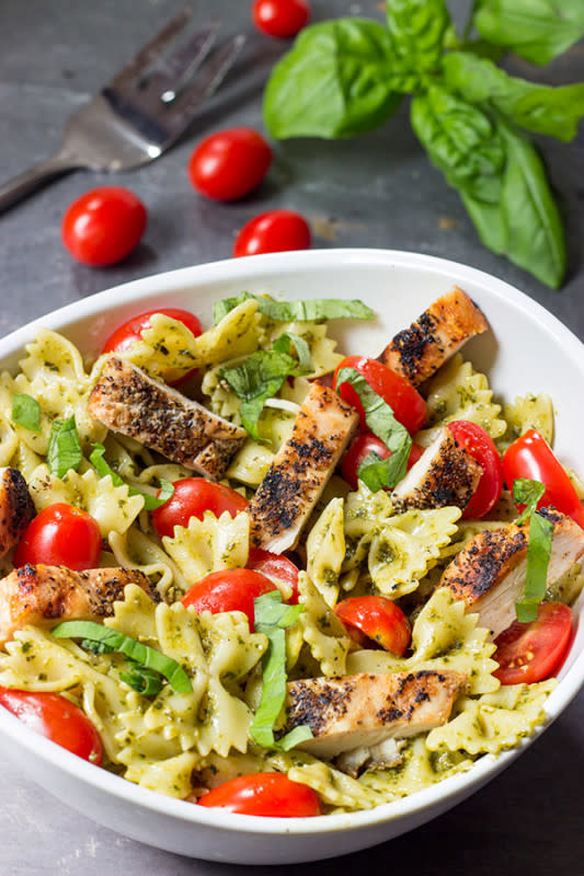 <p>Spiced</p><p>This pesto pasta with grilled chicken is an easy and delicious weeknight meal. Serve it cold as a summer pasta salad or hot as a delicious winter entree!</p><p><strong>Get the recipe: <a href="https://spicedblog.com/pesto-pasta-grilled-chicken#_a5y_p=2417721" rel="nofollow noopener" target="_blank" data-ylk="slk:Pesto Pasta with Grilled Chicken;elm:context_link;itc:0;sec:content-canvas" class="link rapid-noclick-resp"><em>Pesto Pasta with Grilled Chicken</em></a></strong></p>
