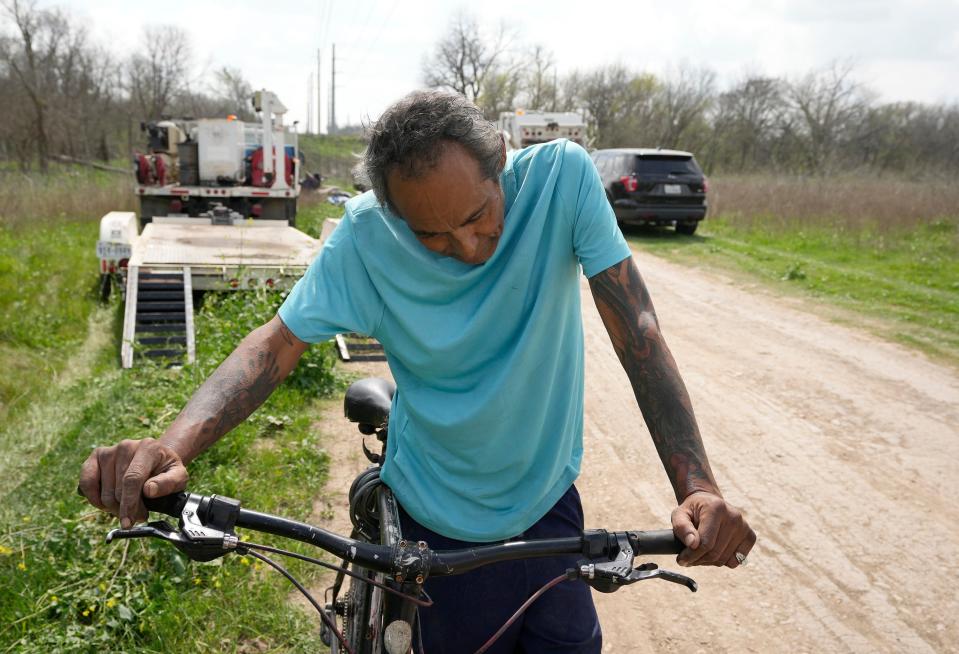 Mario Fonseca, who has been homeless for 15 years, takes a break from pulling a cart with his belongings after he was ousted Monday in a sweep of a homeless encampment in a wooded area off Brandt Road near Onion Creek. Residents said they weren't given any advance warning, just a few minutes to grab whatever belongings they could save before everything else was hauled away in garbage trucks.