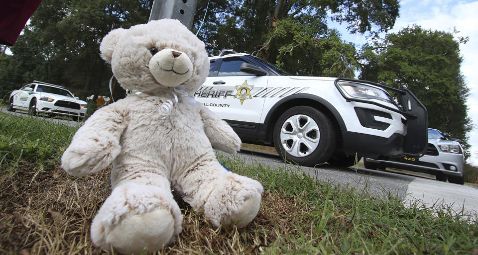 A teddy bear was left at the entrance to Rankin Lake Park in memory of Maddox Ritch, 6, by Robin and Rebekah Marshburn after Maddox's body was found in a nearby creek Thursday, Sept. 27, 2018, in Gastonia, N.C. Last Saturday, Maddox Ritch's father, Ian Ritch, said the boy ran off from him and a friend at the park and disappeared before he could catch up to him. (Mike Hensdill/The Gaston Gazette via AP)