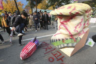 <p>A protester tramples a mock U.S. missile during a rally to oppose the visit by U.S. President Donald Trump in front of the National Assembly in Seoul, South Korea, Nov. 8, 2017. The words on the ground read “Maniac.” (Photo: Ahn Young-joon/AP) </p>