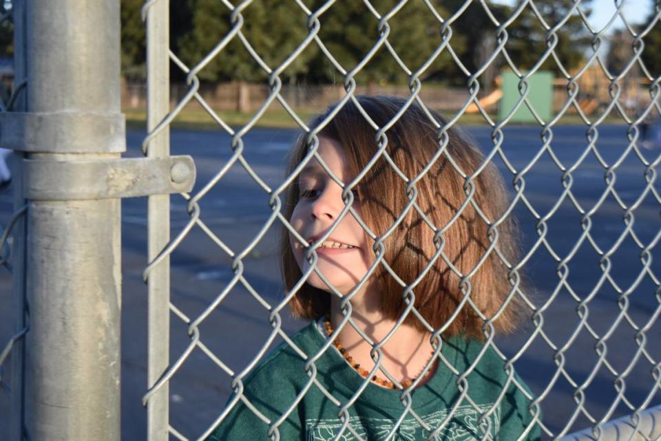 At Sherwood Elementary School in Modesto on Monday, March 14, 2022, first-grader Olivia Sousa looks toward her mom from the playground.