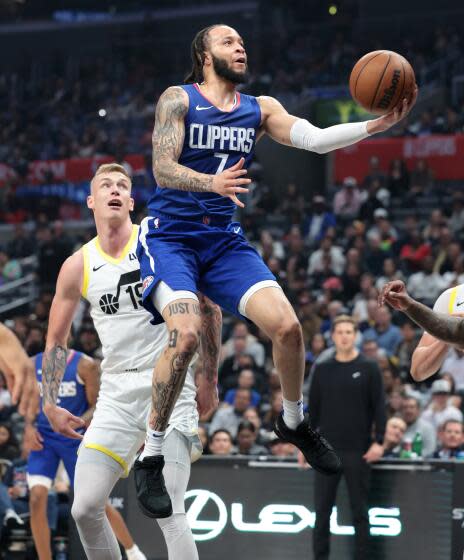 LOS ANGELES, CALIFORNIA - APRIL 12: Clippers Amir Coffey beats the Jazz defense.