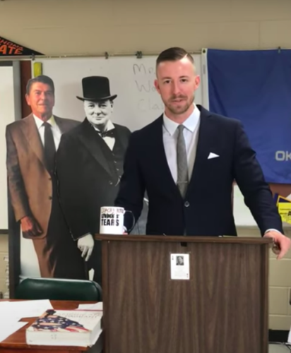 Ryan Walters displayed his cut-outs of Reagan and Churchill as he gave his farewell speech to students at McAlester High School. (Courtesy of Starla Edge)