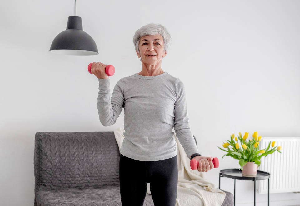 Elderly Sweet Woman Exercises With Dumbbells, Embracing Active Lifestyle And Home Workouts�