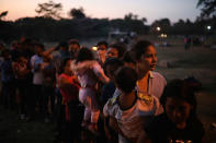 <p>Central American migrant women and children stand in line for food during the annual Migrant Stations of the Cross caravan as the group sets up camp at a sports center in Matias Romero, Oaxaca state, Mexico, late Monday, April 2, 2018. (Photo: Felix Marquez/AP) </p>