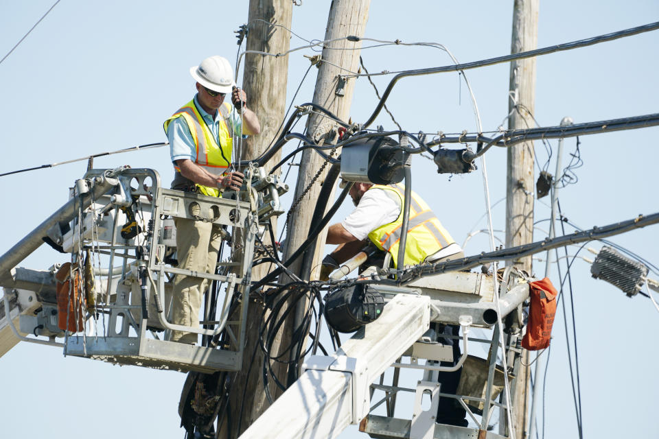 Telephone company linemen repair landlines during recovery from the March 24 killer tornado that rolled through Rolling Fork, Miss., on March 29, 2023. Many area residents are hopeful the county seat will be rebuilt with improvements to the city's infrastructure. (AP Photo/Rogelio V. Solis)