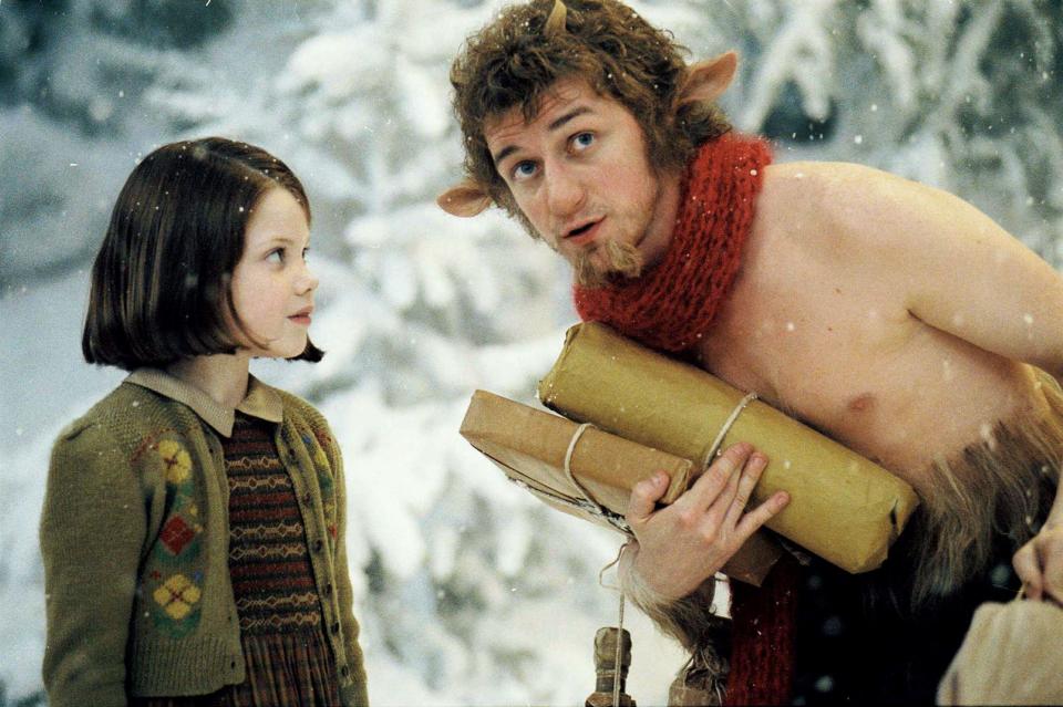 Georgie Henley as Lucy Pevensie turns to face James McAvoy as the fawn Mr. Tumnus in the snow in The Chronicles of Narnia: The Lion, The Witch, and The Wardrobe