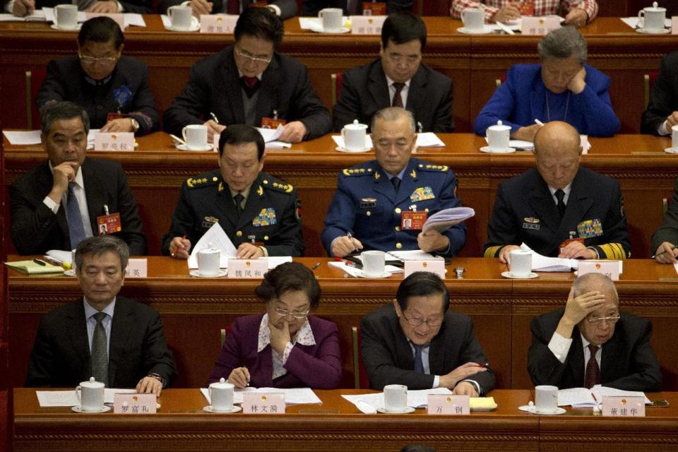 Former Chief Executive of Hong Kong Tung Chee-hwa, lower right, and current Hong Kong Chief Executive Leung Chun-ying, left at second row, attend the opening session of the annual National People's Congress in Beijing's Great Hall of the People, Sunday, March 5, 2017. China's top leadership as well as thousands of delegates from around the country are gathered at the Chinese capital for the annual legislature meetings. (AP Photo/Ng Han Guan)