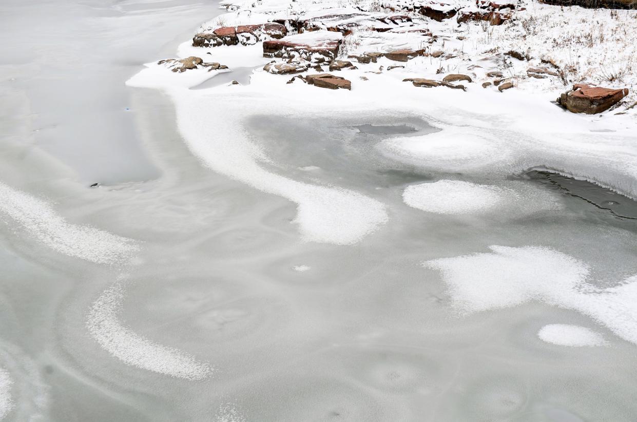 The Big Sioux River freezes over near downtown on Tuesday, November 29, 2022, in Sioux Falls.