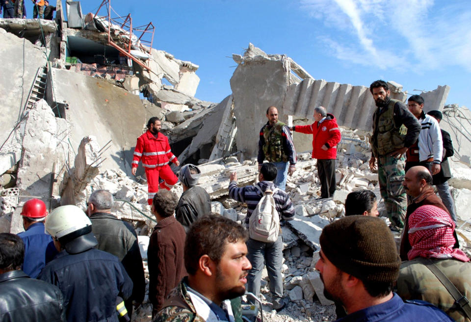 In this photo released by the Syrian official news agency SANA, Syrian citizens and security forces gather at site where a car bomb has exploded near a school, at al-Kaffat village in the central Hama province, Syria, Thursday Jan. 9, 2013. Syrian state media and an opposition watchdog say a car bomb has exploded near a school in a central province, killing several people and wounding dozens. (AP Photo/SANA)