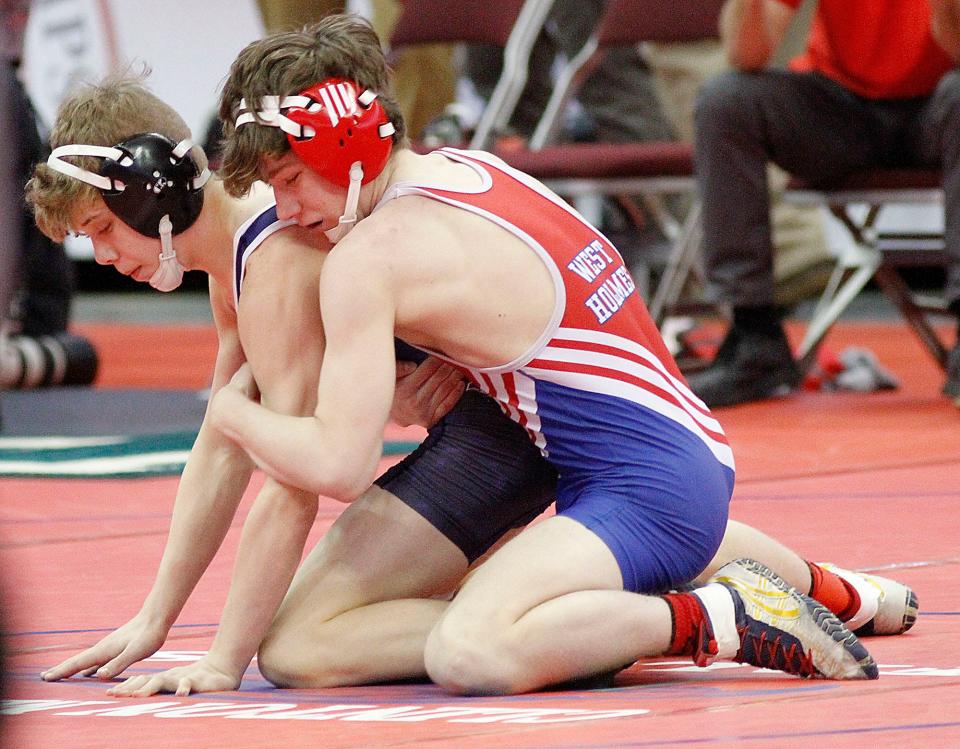 West Holmes' Mason Taylor wrestles Defiance's Mason Ducat during their match Friday, March 11, 2022 at the OHSAA State Wrestling Championship at the Jerome Schottenstein Center in Columbus. TOM E. PUSKAR/TIMES-GAZETTE.COM