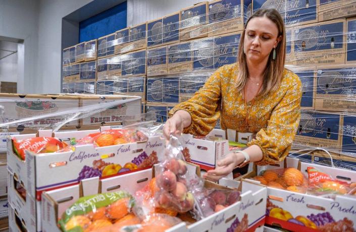 Natalie Caples, co-CEO of the Central California Food Bank, looks over fresh produce packed in the food bank&#x002019;s warehouse in Fresno on Monday, June 8, 2020.