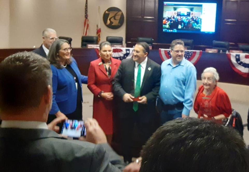 Outgoing council members Tony Madrigal, center, and Jenny Kenoyer, right, pose for pictures Tuesday, Nov. 29, 2022, with, from left, Mayor Sue Zwahlen, Councilwoman Rosa Escutia-Braaton and Councilman Chris Ricci. Councilman David Wright is behind Zwahlen.