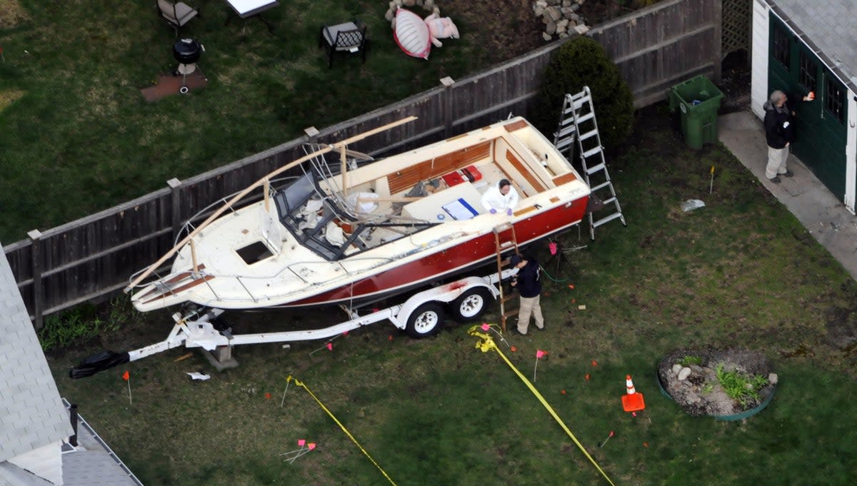 Investigators work around the boat where DzhokharTsarnaev was found hiding after a massive manhunt, in the backyard of a Franklin Street home, in an aerial view, on 20 April 2013 in Watertown, Massachusetts (Darren McCollester/Getty Images)