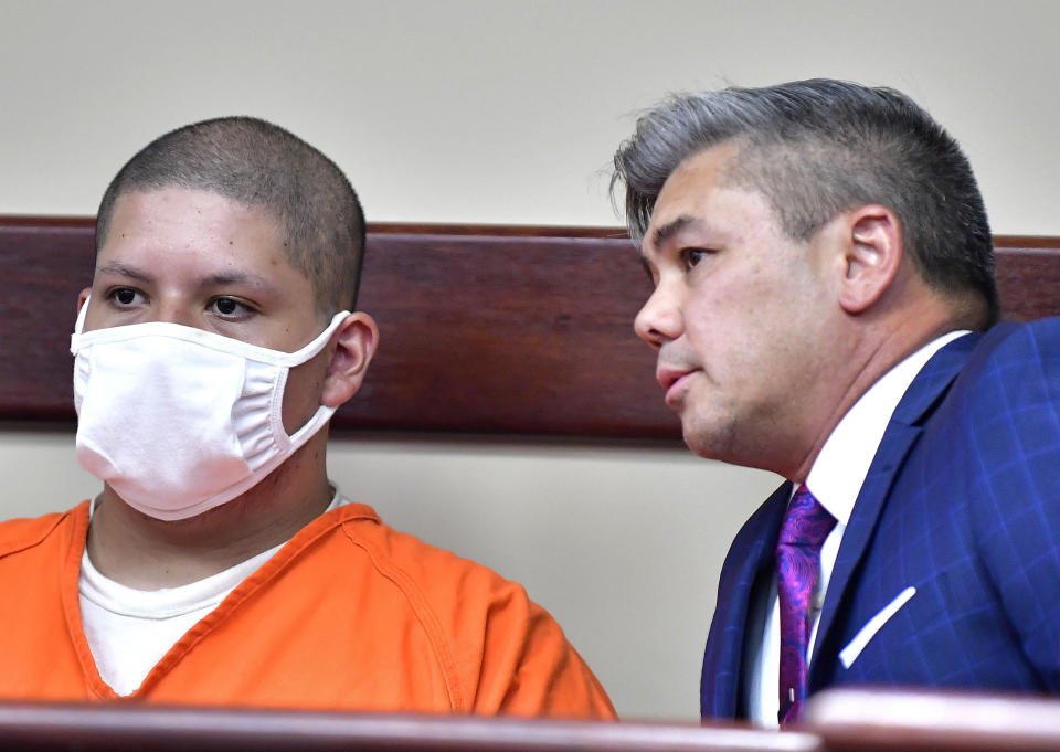 FILE - In this July 30, 2021 file photo Joseph Jimenez, 20, left, appears with his attorney Charles Kenyon in the Riverside Hall of Justice, in Riverside, Calif. Jimenez, a man suspected of shooting two people, killing one, inside a Southern California movie theater has been charged with murder and attempted murder, prosecutors said. The young man who had been on life support after he and a friend were shot has died, police and his family said Saturday, July 31, 2021. (Will Lester/The Orange County Register via AP,File)