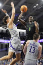 Chicago State guard Wesley Cardet Jr. (1) drives to the basket against Northwestern guard Ty Berry, left, and guard Brooks Barnhizer (13) during the second half of an NCAA college basketball game in Evanston, Ill., Wednesday, Dec. 13, 2023. (AP Photo/Nam Y. Huh)