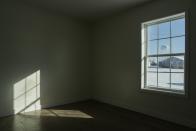 Light shines through a window of a newly built house in an area previously destroyed by a tornado, Tuesday, Jan. 16, 2024, in Mayfield, Ky. Experts say the intersections of affordable housing and climate change can be felt everywhere. (AP Photo/Joshua A. Bickel)