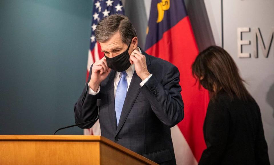 Gov. Roy Cooper removes his mask before speaking during a briefing on North Carolina’s coronavirus pandemic response Tuesday, Jan. 12, 2021 at the NC Emergency Operations Center in Raleigh.