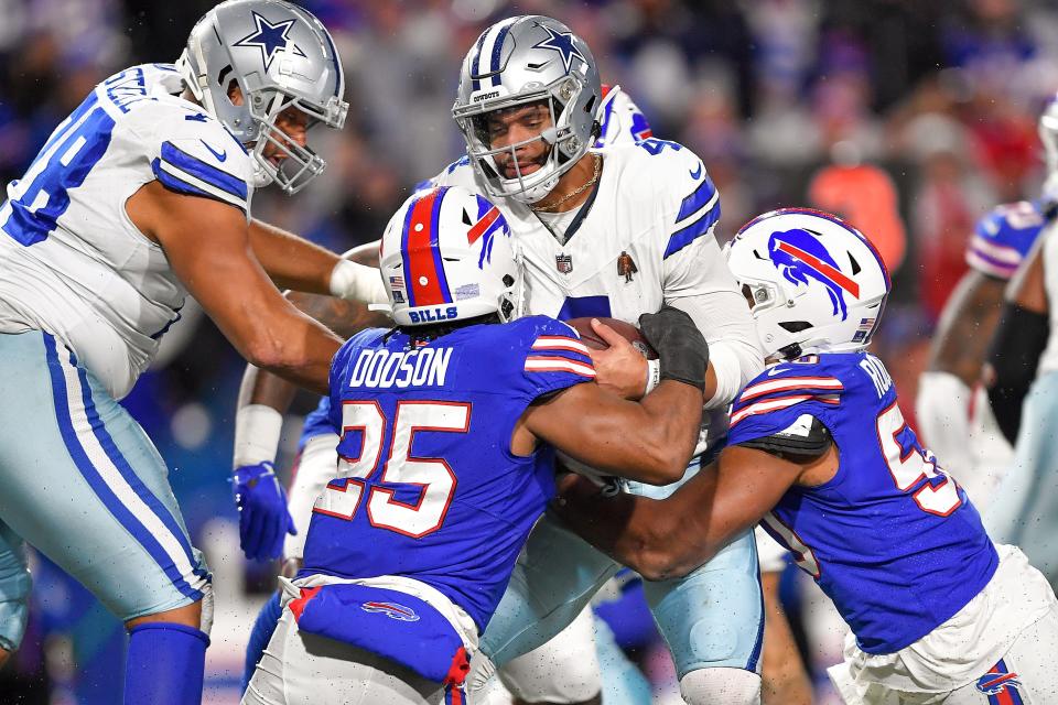 Dallas Cowboys quarterback Dak Prescott (4) is sacked by Buffalo Bills linebacker Tyrel Dodson (25) and Buffalo Bills defensive end Greg Rousseau (50) during the third quarter of an NFL football game, Sunday, Dec. 17, 2023, in Orchard Park, N.Y. (AP Photo/Adrian Kraus)