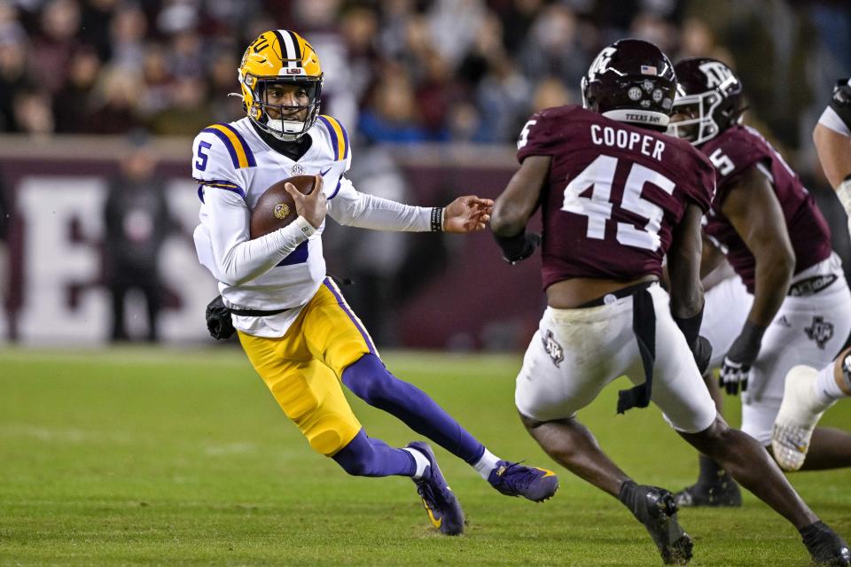 Nov 26, 2022; College Station, Texas, USA; <a class="link " href="https://sports.yahoo.com/ncaaf/teams/lsu/" data-i13n="sec:content-canvas;subsec:anchor_text;elm:context_link" data-ylk="slk:LSU Tigers;sec:content-canvas;subsec:anchor_text;elm:context_link;itc:0">LSU Tigers</a> quarterback <a class="link " href="https://sports.yahoo.com/ncaaf/players/299079" data-i13n="sec:content-canvas;subsec:anchor_text;elm:context_link" data-ylk="slk:Jayden Daniels;sec:content-canvas;subsec:anchor_text;elm:context_link;itc:0">Jayden Daniels</a> (5) and Texas A&M Aggies linebacker Edgerrin Cooper (45) in action during the game between the Texas A&M Aggies and the LSU Tigers at Kyle Field. Mandatory Credit: Jerome Miron-USA TODAY Sports