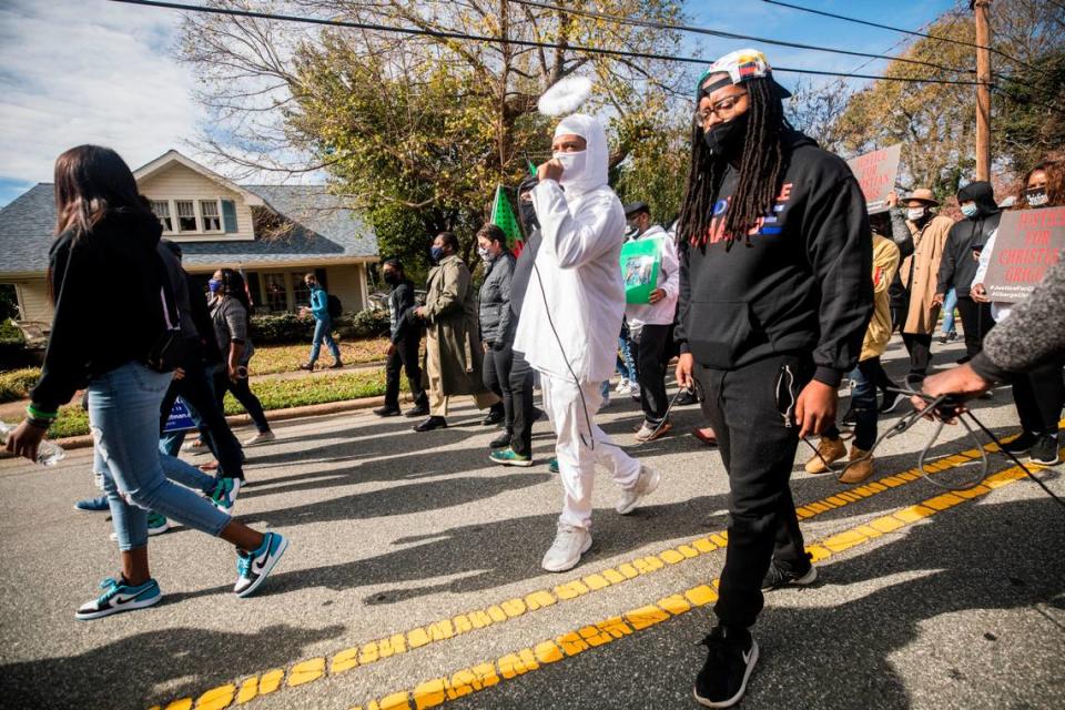 Demonstrators participating in the march to the polls in Graham chant the names of people killed by police as they march towards the Alamance County Historic Courthouse on Oct. 31, 2020.